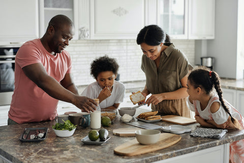family in the kitchen cooking with le sauce